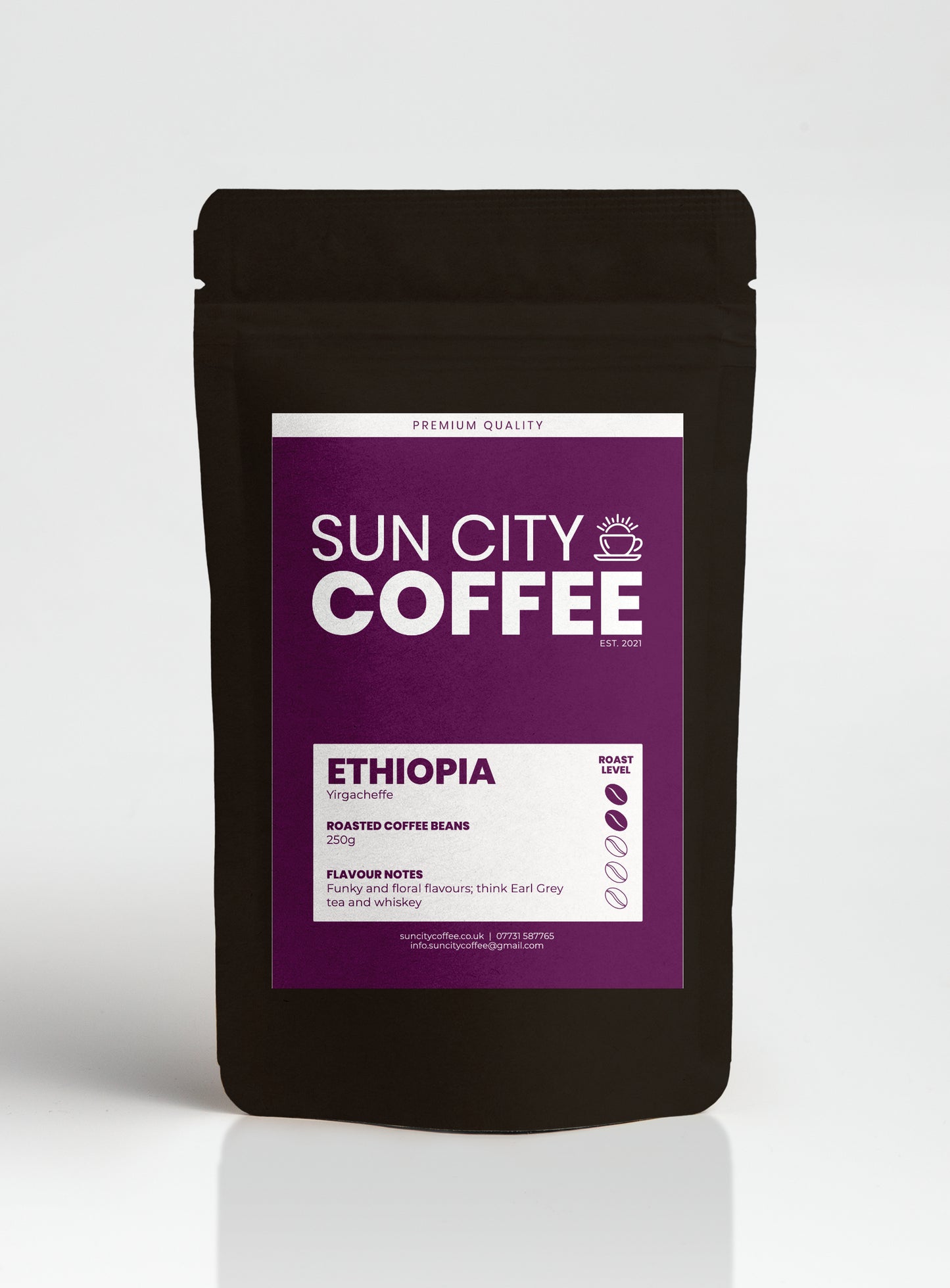 A packaged bag of Sun City Coffee Ethiopia yiracheffe single origin coffee, which is a light roast coffee with purple label