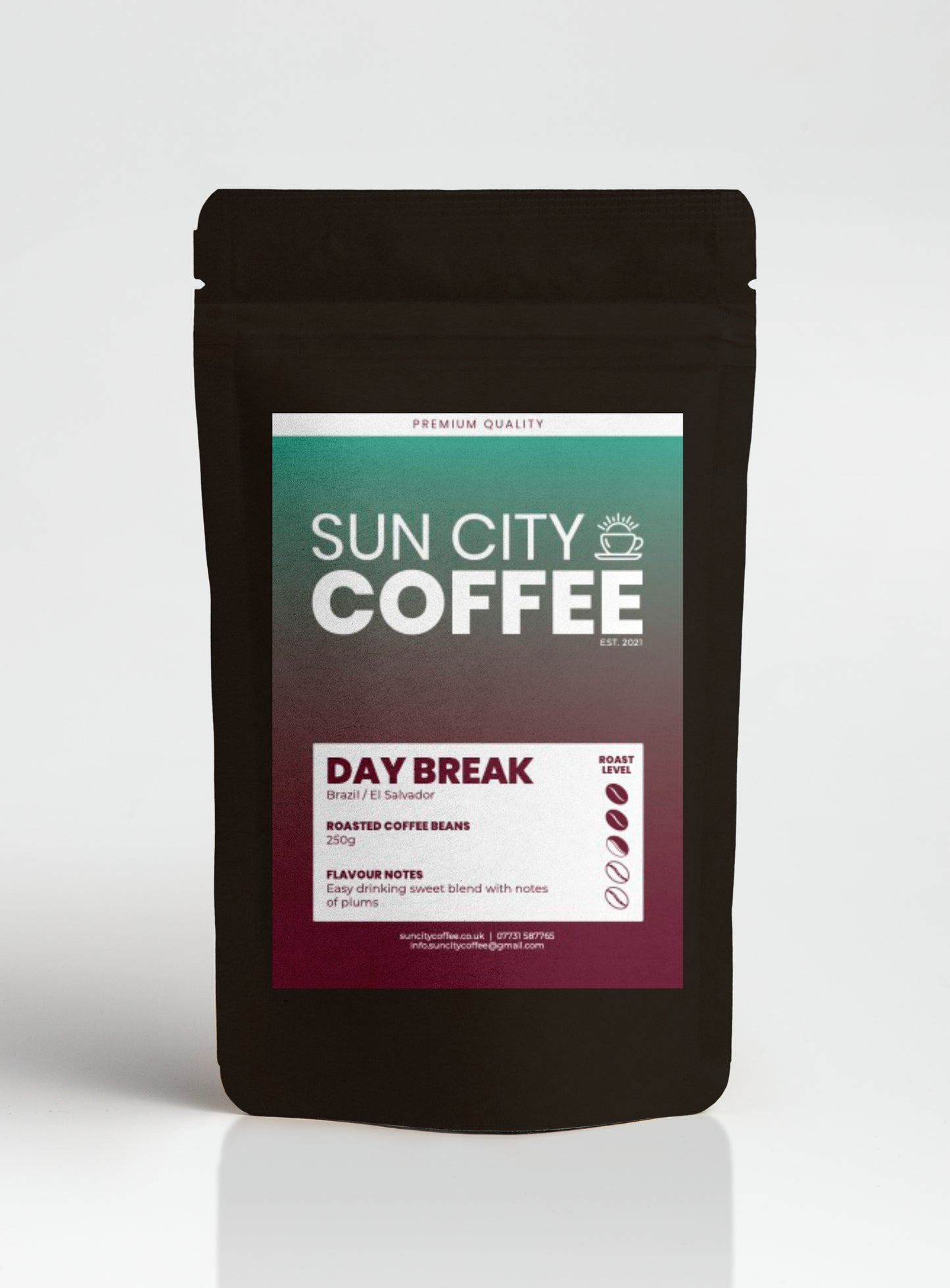 A packaged bag of Sun City Coffee's Day Break Blend single origin beans from Brazil & El Salvador in a black bag with colouful label