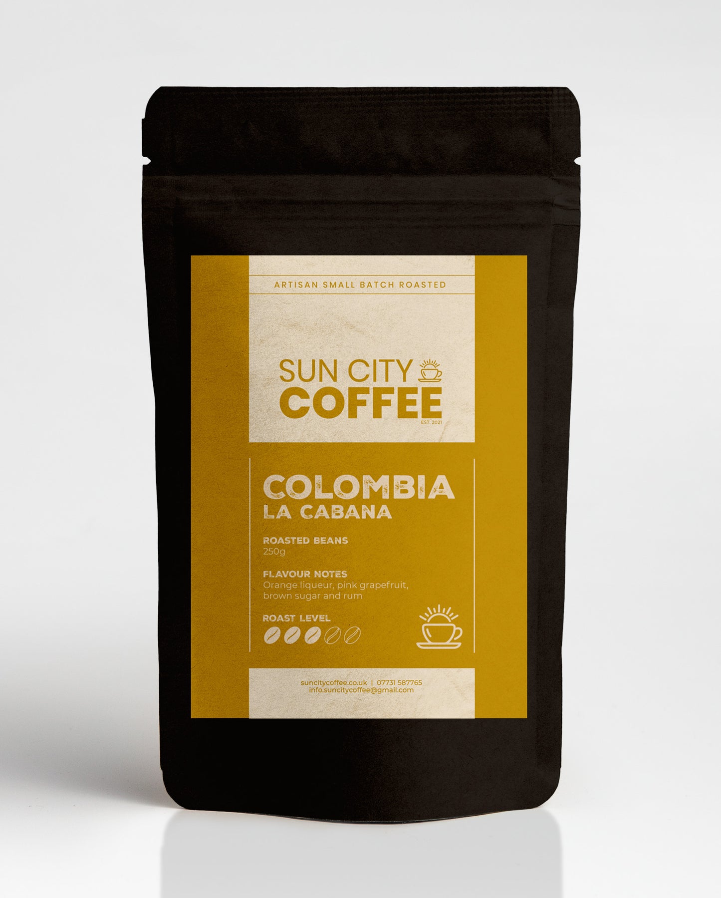 A pack of Sun City Coffee Colombia La Cabana single origin coffee with gold label and black bag