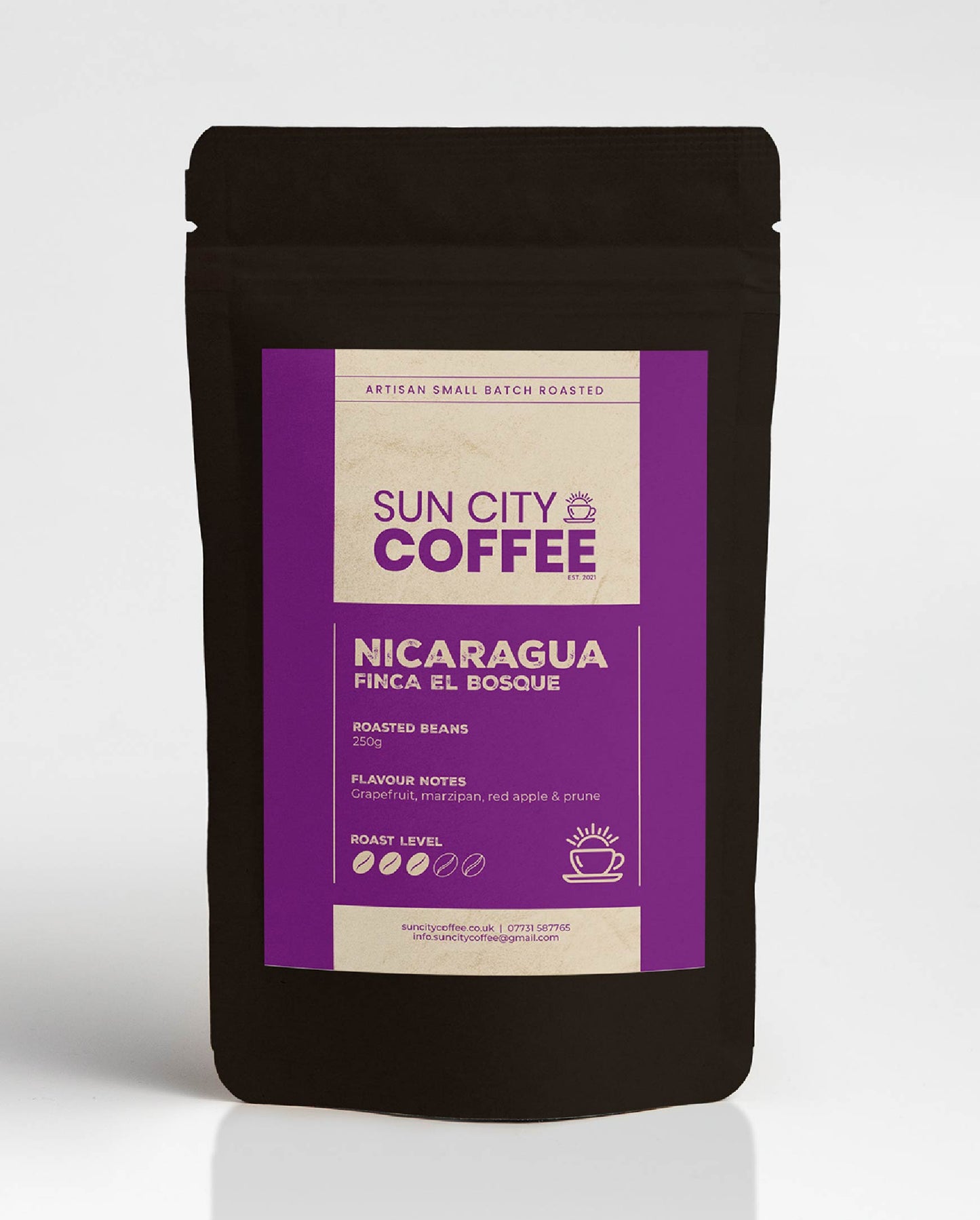 A pack of Sun City Coffee Nicaragua Finca El Bosque single origin coffee with bright purple label and black bag