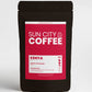 A pack of Sun City Coffee, Kenya AA single origin coffee with a red pink label and black packaging.
