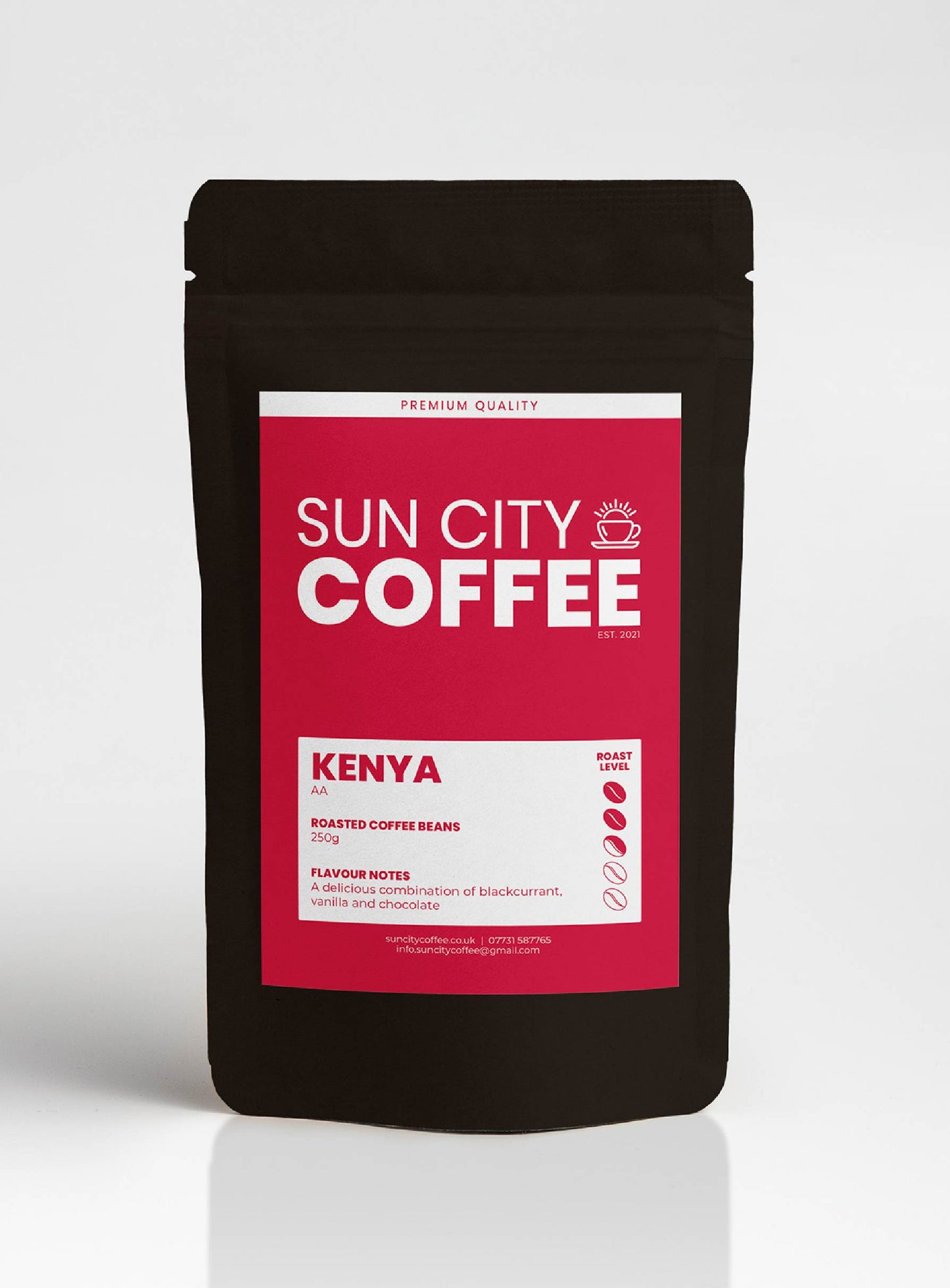 A pack of Sun City Coffee, Kenya AA single origin coffee with a red pink label and black packaging.