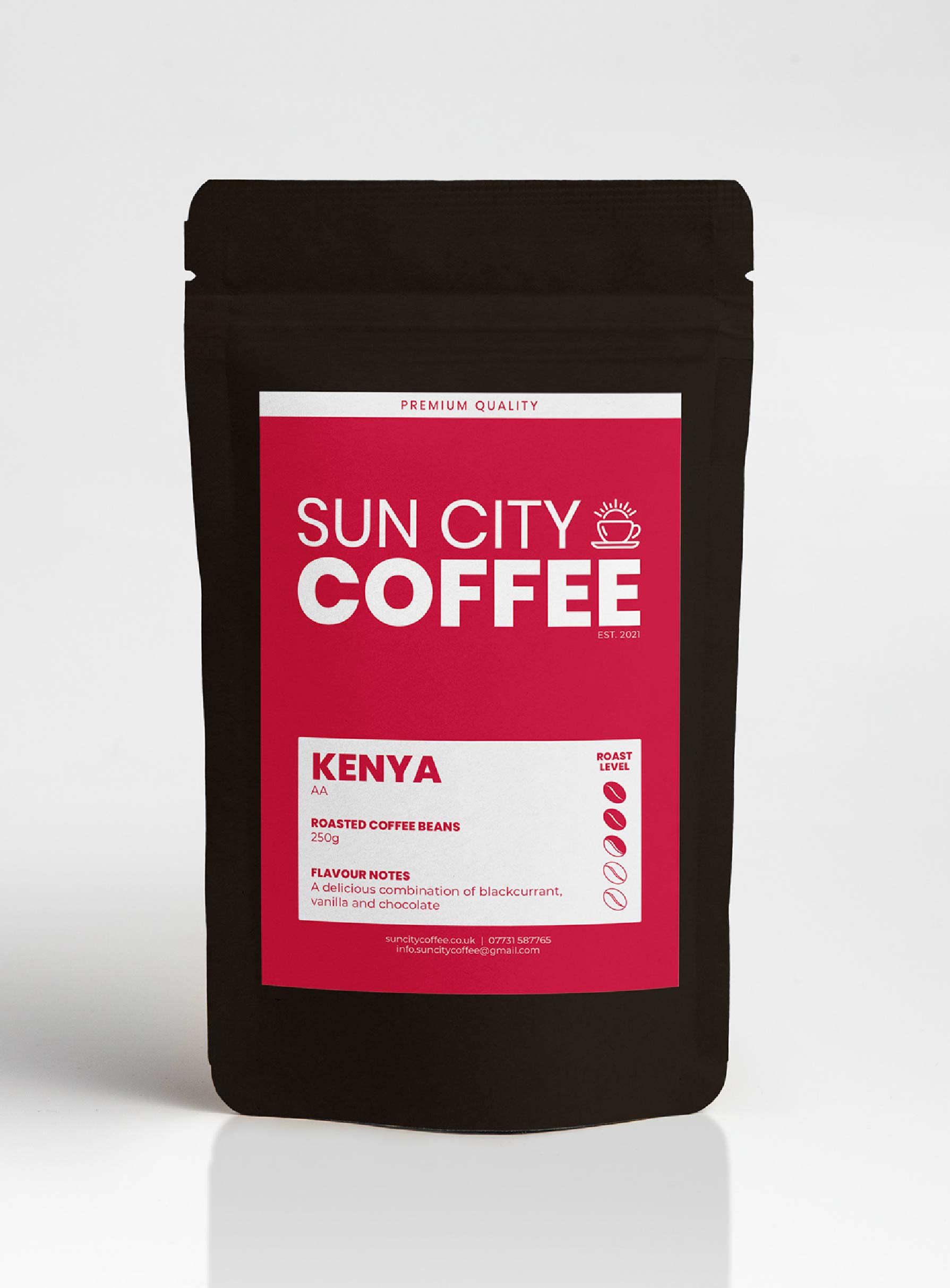 A pack of Sun City Coffee, Kenya AA single origin coffee with a red pink label and black packaging.