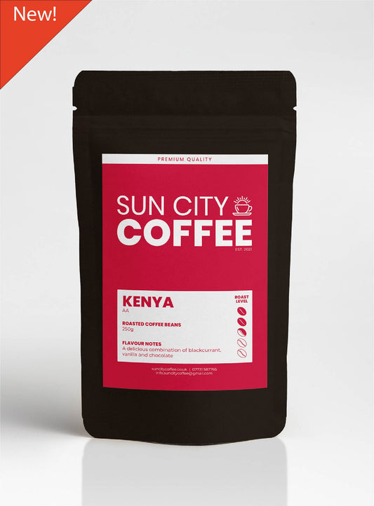 A pack of Sun City Coffee, Kenya AA single origin coffee with a red pink label and black packaging with red triangle with word new in top left corner