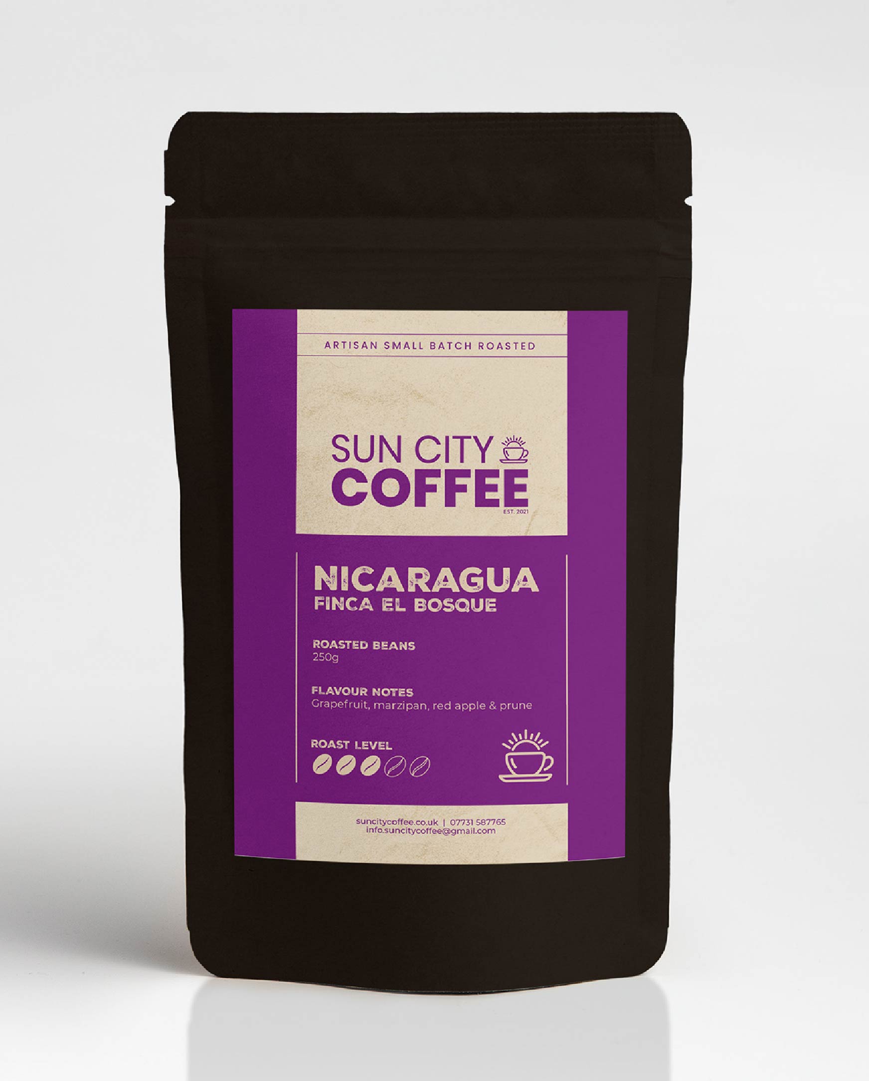 A pack of Sun City Coffee Nicaragua Finca El Bosque single origin coffee with bright purple label and black bag